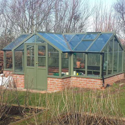 t-shaped wooden greenhouse in garden