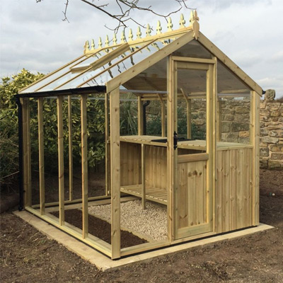 wooden 6x4 greenhouse in garden with dirt foundation