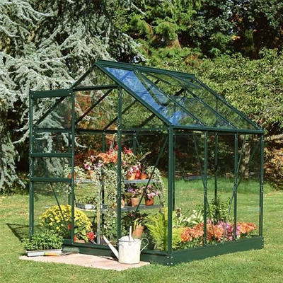green aluminium greenhouse in garden