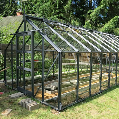 large greenhouse black in garden