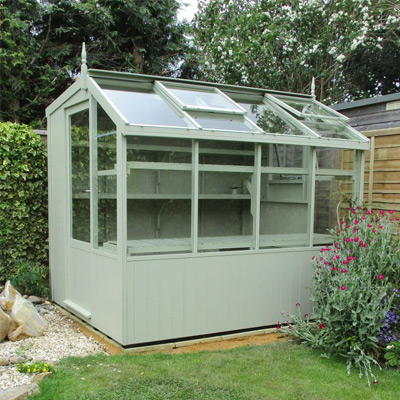 green lean to wooden potting shed