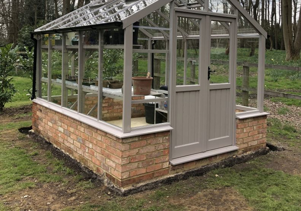 solid concrete greenhouse base in garden