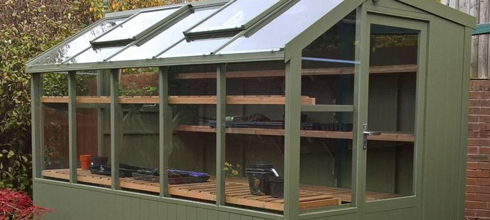 green potting shed with shelves