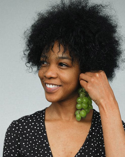 women wearing grapes as earings