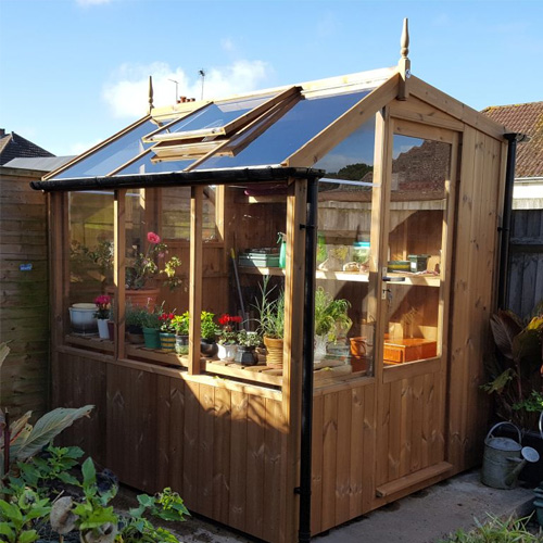 wooden potting shed in garden