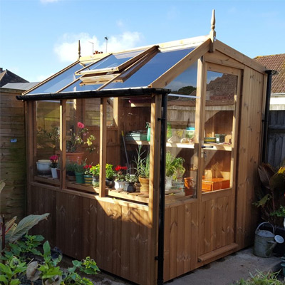 small wooden potting shed in garden