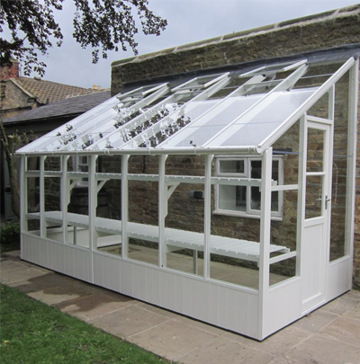 white wooden lean to greenhouse
